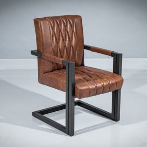 Three-quarter view of a metal dining armchair. Powder-coated metal frame in geometrical shape and dark gray matte finish. Seat and backrest upholstered in real brown leather with diamond-shape pattern.