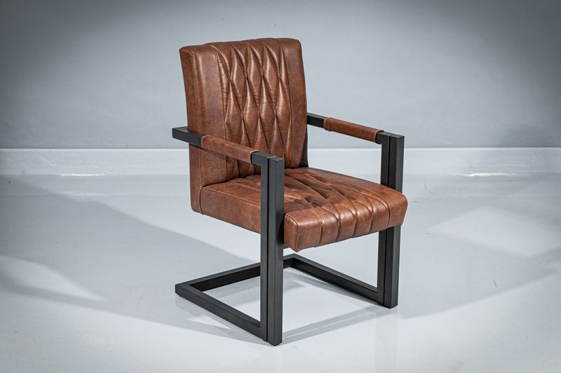Three-quarter view of a metal dining armchair. Powder-coated metal frame in geometrical shape and dark gray matte finish. Seat and backrest upholstered in real brown leather with diamond-shape pattern.