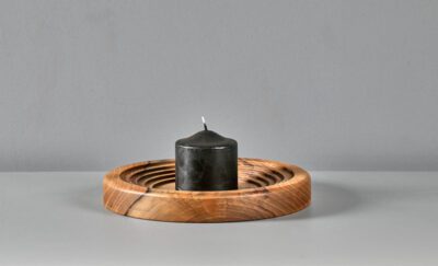 Solid walnut construction ring design. Smooth, hand- finished surface. Natural wood grain variation with engraved center logo